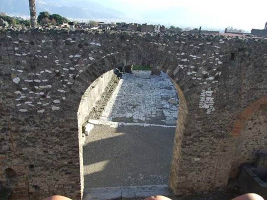 Arched entrance in north-west corner of Forum. December 2007. Looking down from roof of restaurant at VII.5.19.
