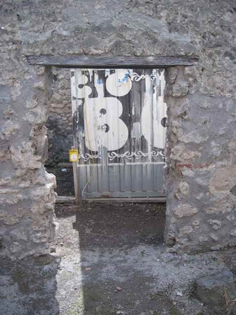 I.2.19 Pompeii. September 2010. Entrance doorway from across Vicolo del Citarista, looking west into rear of I.2.18. Photo courtesy of Drew Baker.
