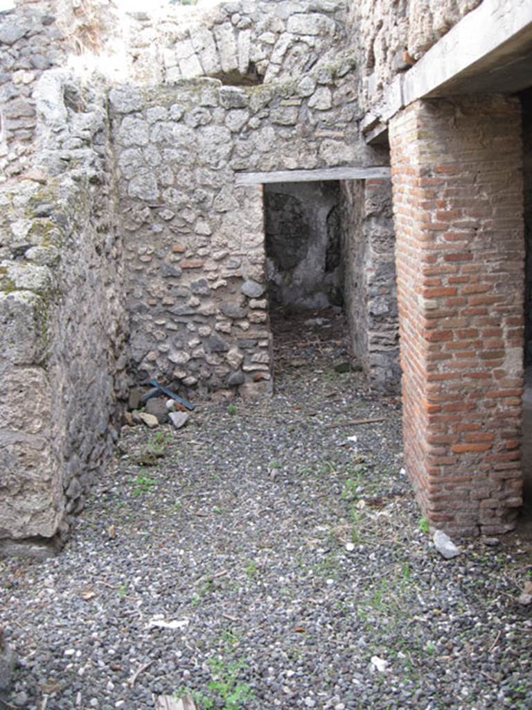 I.3.3 Pompeii. September 2010. Looking east across area of wider corridor, from north end of narrow corridor. On the left can be seen the doorway to the second triclinium, ahead is a doorway to an area that Fiorelli called il repositorio. On the right are the two doorways to the kitchen area.  Photo courtesy of Drew Baker
