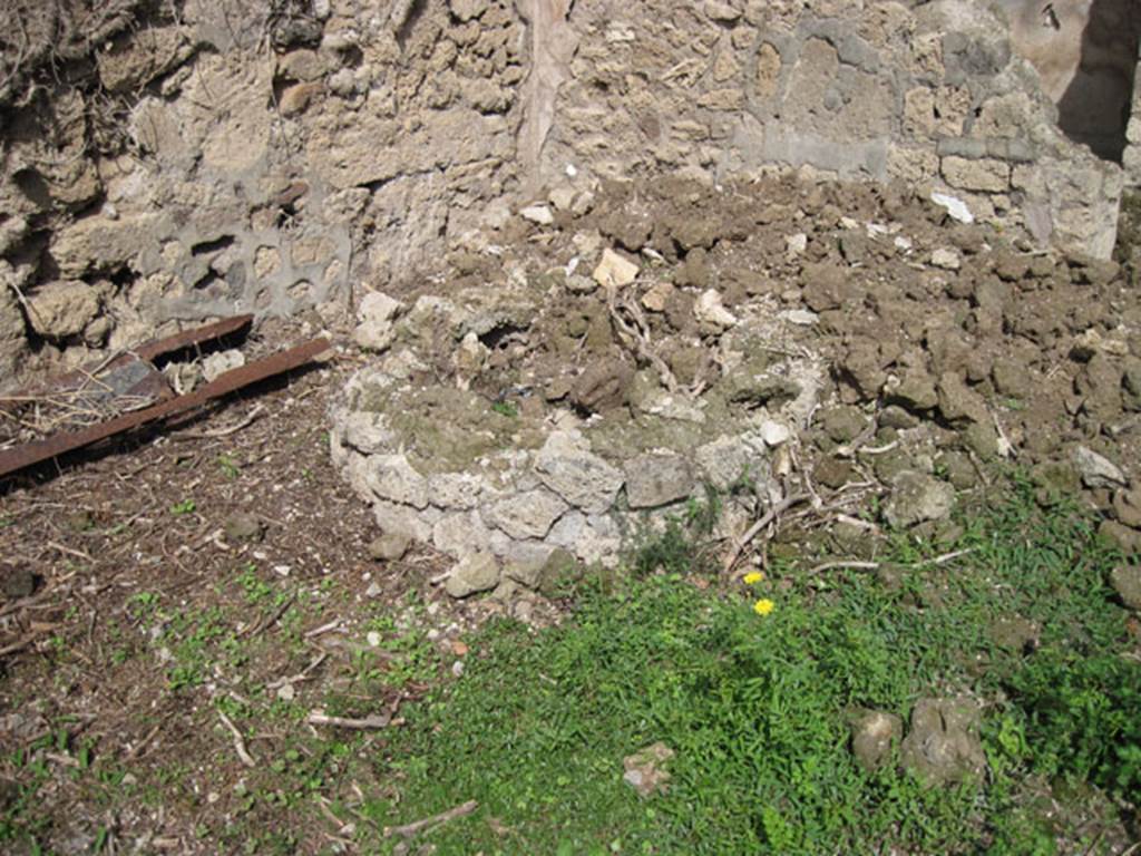 I.3.27 Pompeii. September 2010. 
Looking east to circular feature (base of millstone) at east end of north wall of bakery room. 
Photo courtesy of Drew Baker.
