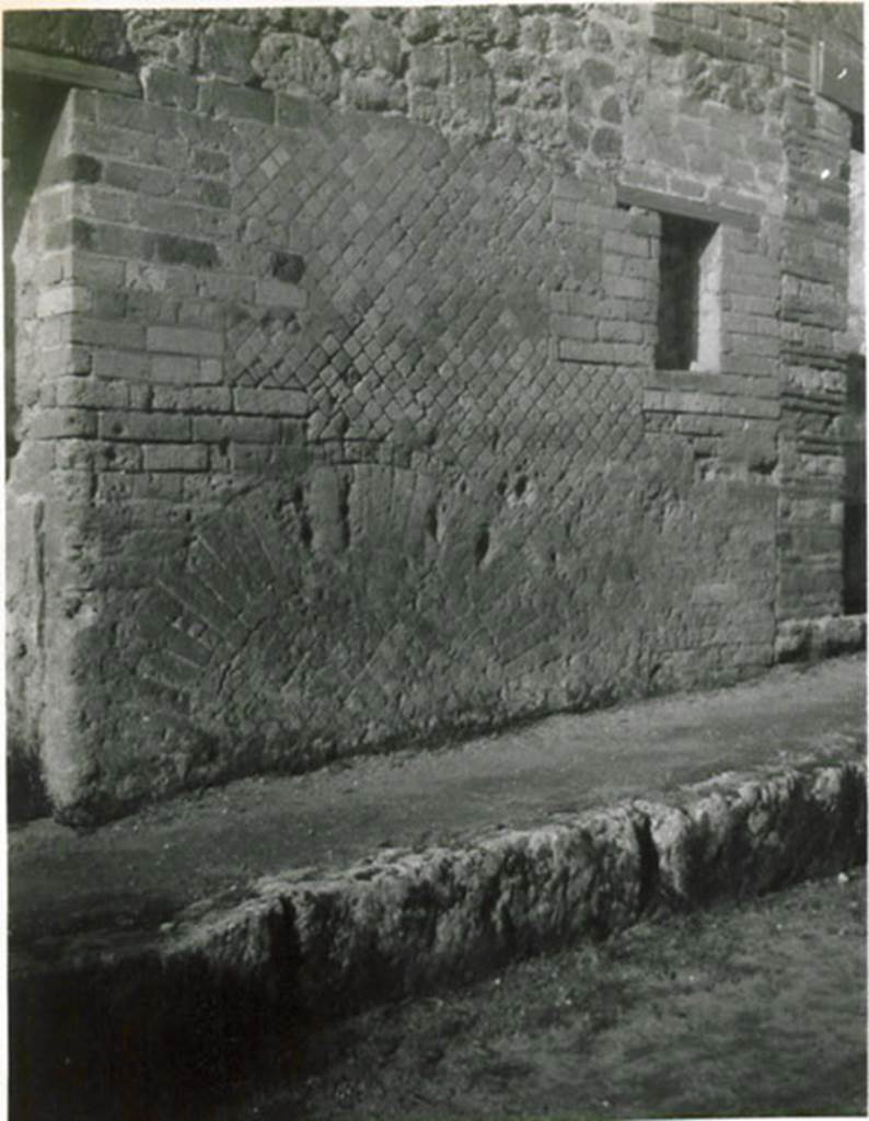 I.3.29 Pompeii. 1935 photograph taken by Tatiana Warscher. Looking towards street facade on north side of entrance doorway, between I.3.29 and I.3.28.  
See Warscher, T, 1935: Codex Topographicus Pompejanus, Regio I, 3: (no.76), Rome, DAIR, whose copyright it remains.  
