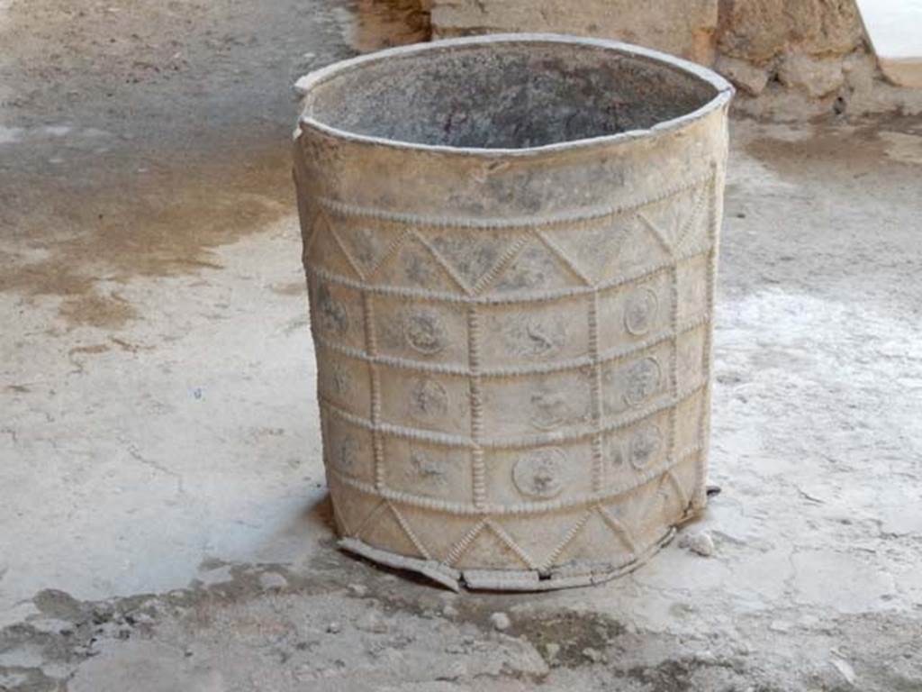 I.7.3 Pompeii. May 2016. Laminated cylindrical lead bucket with relief of zodiac signs, in atrium.  Photo courtesy of Buzz Ferebee.
