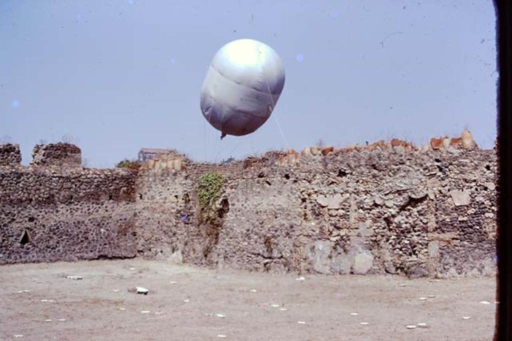 I.20.5 Pompeii. 1974. Looking towards north-west corner, and the balloon in Via della Palestra.  Photo by Stanley A. Jashemski.   
Source: The Wilhelmina and Stanley A. Jashemski archive in the University of Maryland Library, Special Collections (See collection page) and made available under the Creative Commons Attribution-Non Commercial License v.4. See Licence and use details. J74f0442
