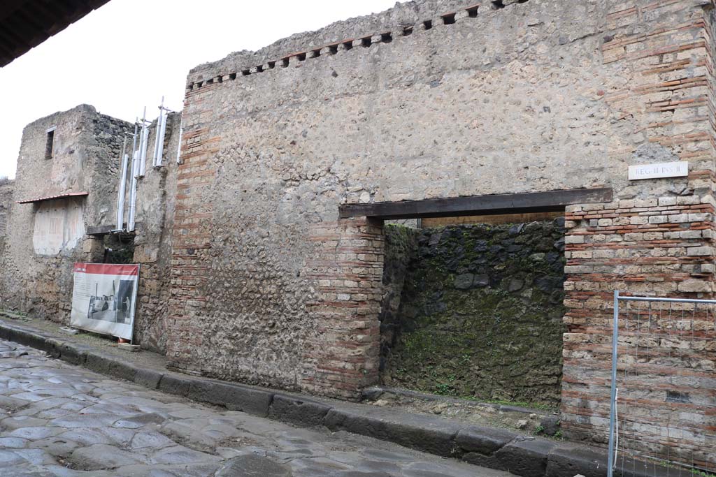 III.2.2 Pompeii, on left and III.2.3, on right. December 2018. 
Entrance doorways on north side of Via dellAbbondanza. Photo courtesy of Aude Durand.
