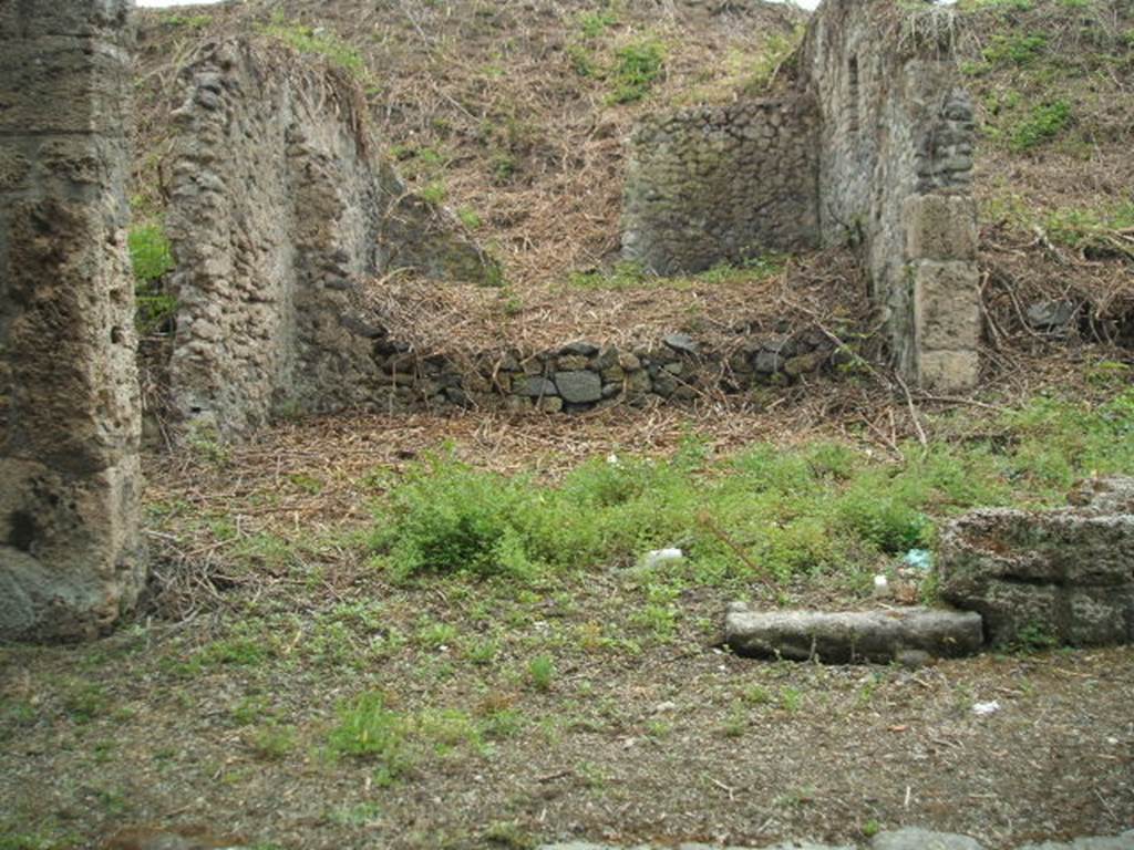 III.11.1 Pompeii.  May 2005.  Shop room of caupona in centre, with side room (on the left).  Looking south.

It is difficult to reconcile the entrances in this insula with the plans as the entrances onto Via Nola have been filled in or are unexcavated.