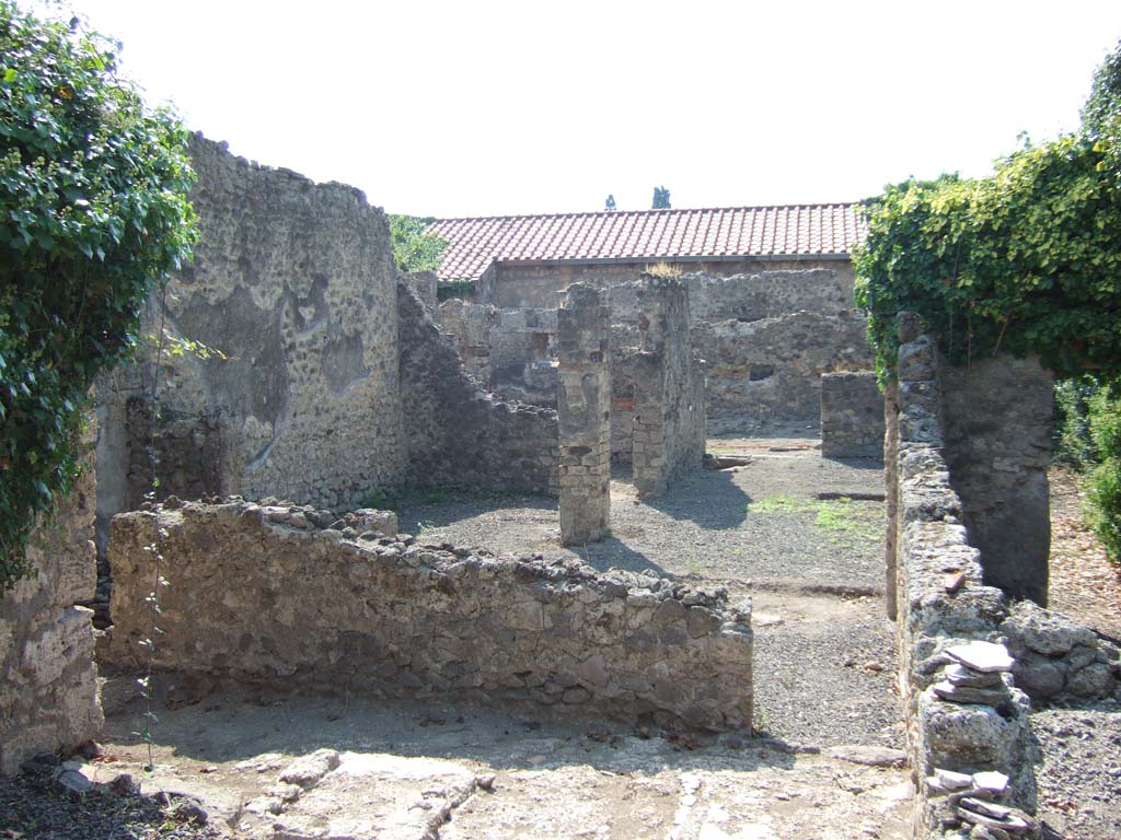 VI.11.17 looking towards VI.11.4 Pompeii. September 2005. Looking west from corridor (8) towards small courtyard (or yard).
On the south side of the entrance doorway at VI.11.4, upper centre, is cubiculum (3), room (4)is on the south side of the yard, on the left. 
Behind the wall in corridor (8), lower left, is the area of rooms (5) and (6).
