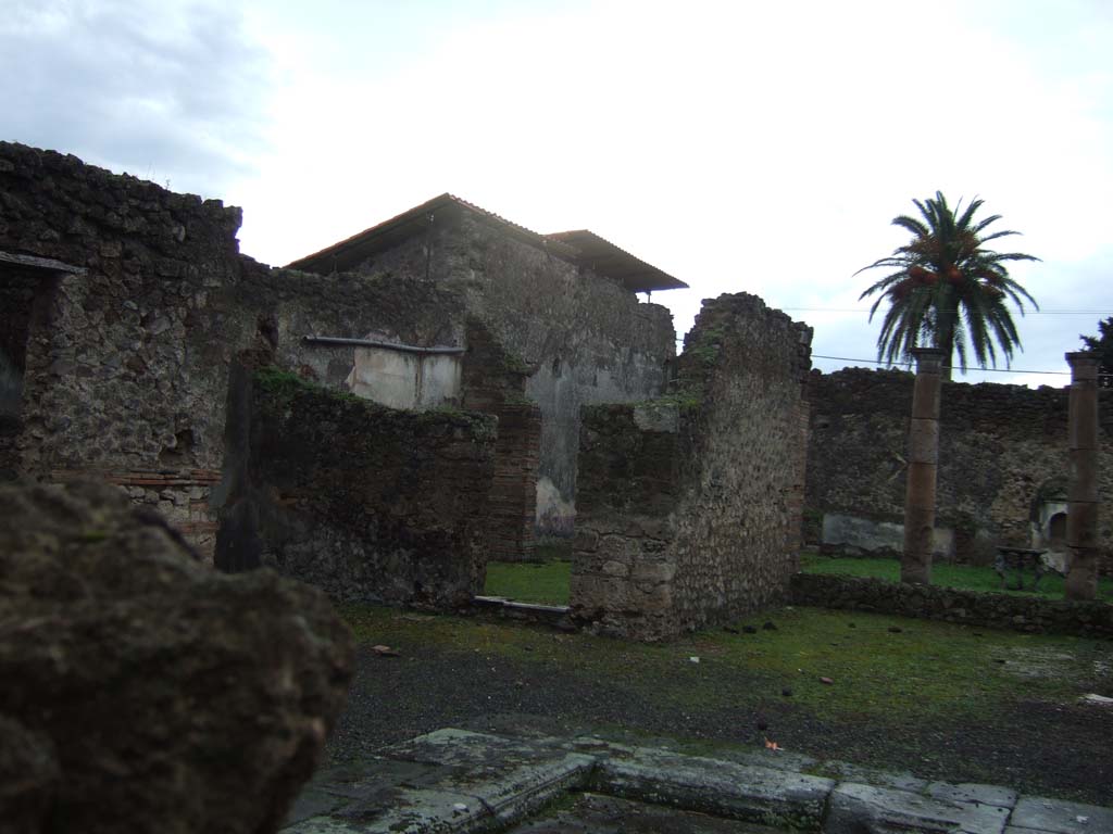 VI.13.13 Pompeii. December 2005. 
Looking south-west across atrium to doorway to triclinium, in west wall of ala on south side of atrium.
