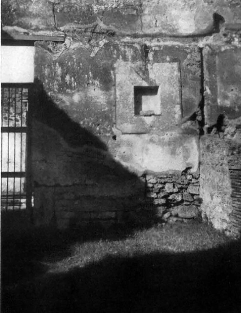 VI.14.19 Pompeii. 1930s photo of lararium niche by Tatiana Warscher.
According to Boyce, in the north wall of the main room (of VI.14.18/19) is a rectangular niche, set 2.10 m above the floor.
It is set in a section of the wall coated with a special panel of white stucco bordered with red stripes.
The inside walls are coated with the same white stucco.
The floor of the niche projects slightly from the surface of the wall.
In the centre of it is set a masonry block to serve either as a base for a statuette or as an altar.
See Boyce G. K., 1937. Corpus of the Lararia of Pompeii. Rome: MAAR 14. (p.52, no.199, with Pl.1, 2) 
