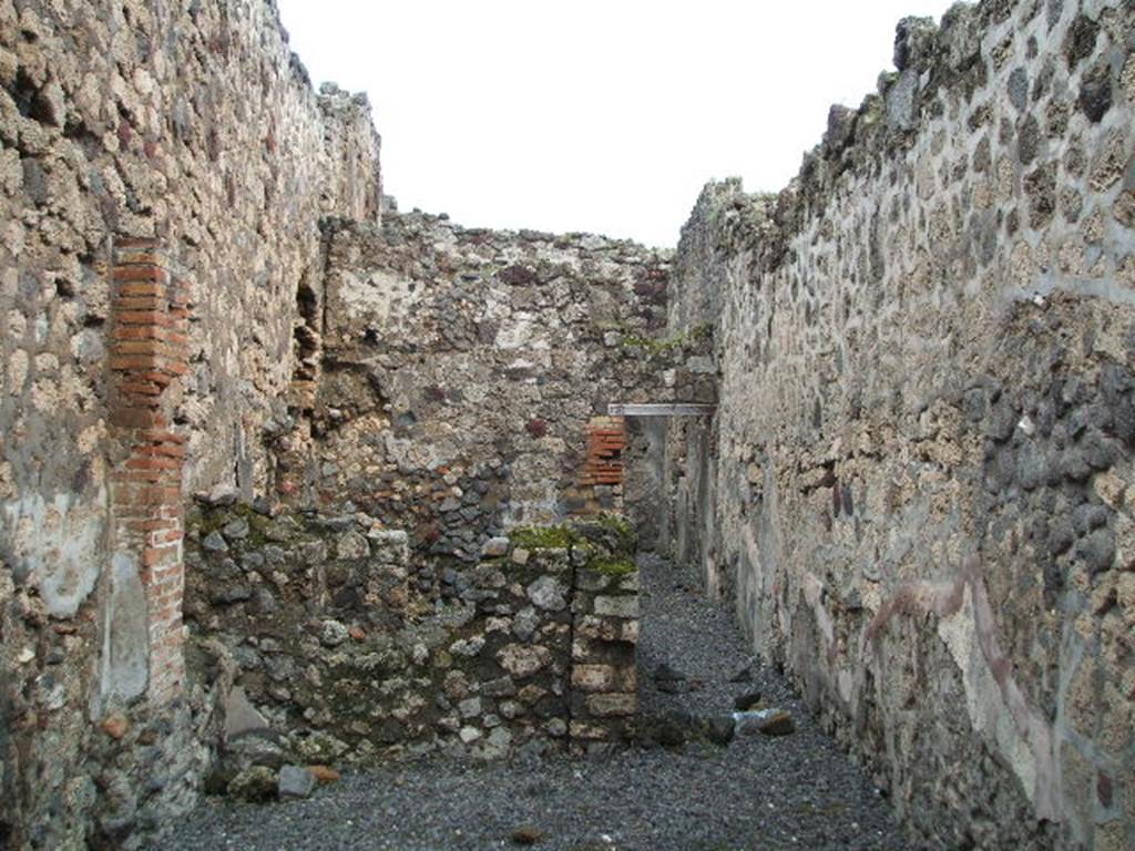 VI.14.41 Pompeii. December 2004. Looking east across workshop towards corridor to rear, on the right. On the left are two rooms. At the rear of the corridor, the doorway leads into a room with steps to the upper floor, and a doorway into the kitchen of VI.14.42. See Eschebach, L., 1993. Gebudeverzeichnis und Stadtplan der antiken Stadt Pompeji. Kln: Bhlau. (p.217)
