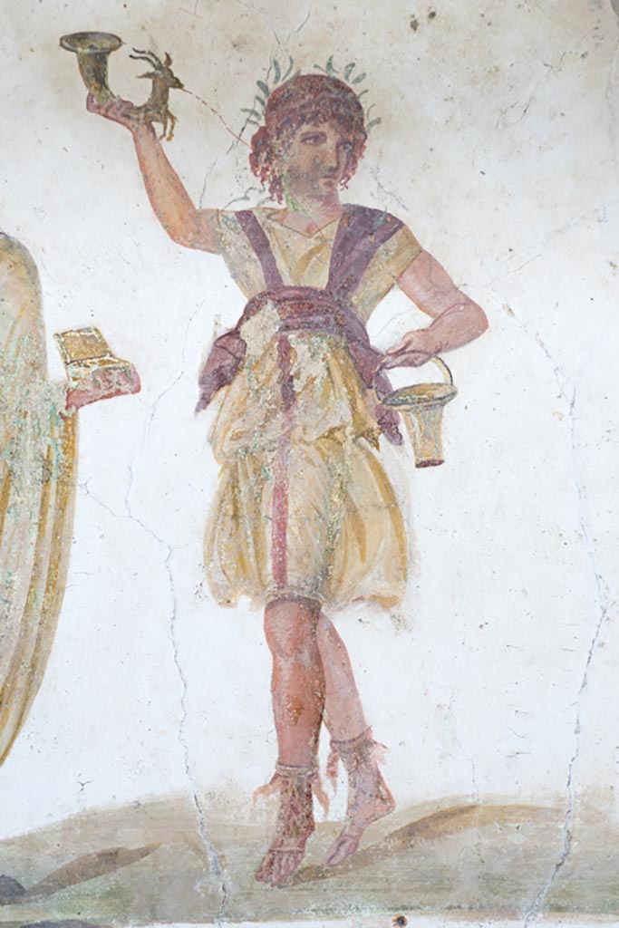 VI.15.1 Pompeii. March 2023.
Detail of wreathed Lar holding rhyton and situla, from north end of lararium painting.
Photo courtesy of Johannes Eber.
