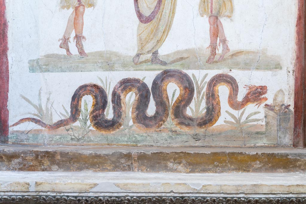 VI.15.1 Pompeii. March 2023. Serpent on lararium painting gliding through plants towards altar. Photo courtesy of Johannes Eber.

