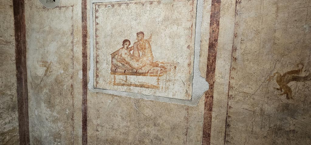 VI.15.1 Pompeii. December 2023. Detail of wall decoration on either side of erotic painting. Photo courtesy of Miriam Colomer.