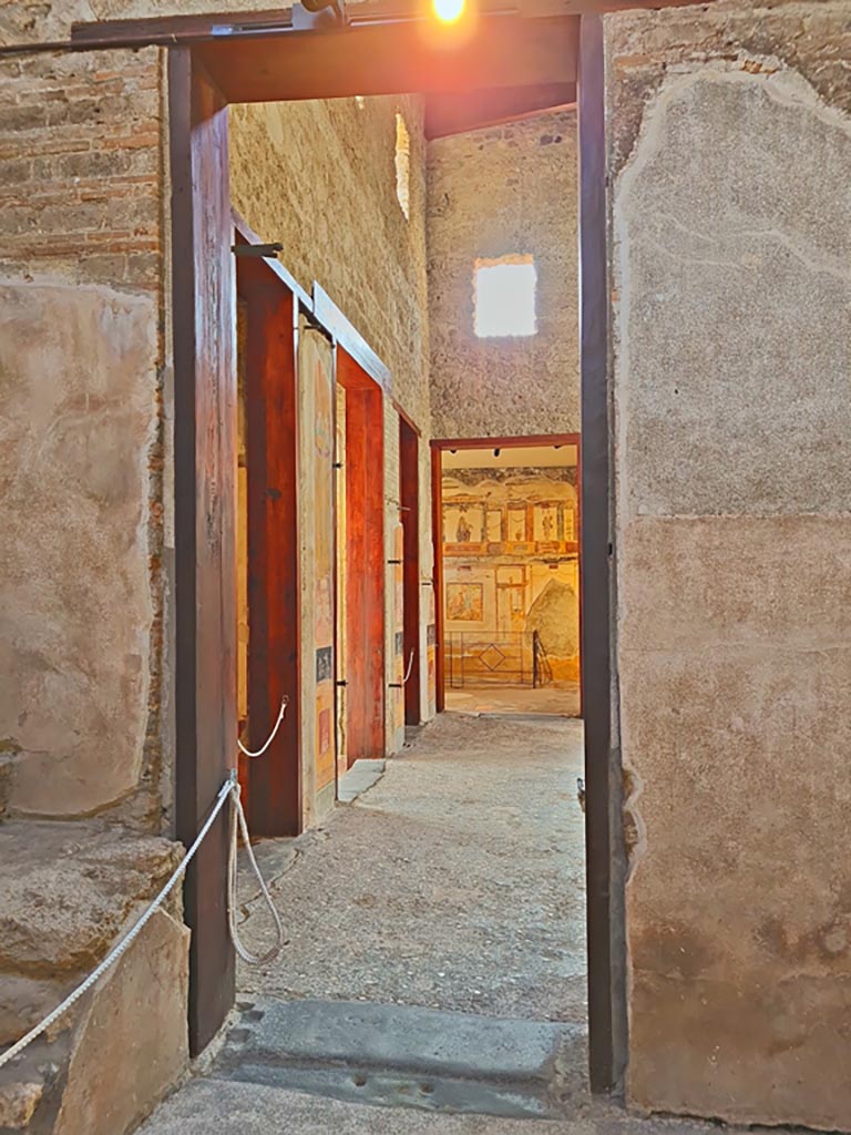 VI.15.1 Pompeii. April 2023. 
Looking south through doorway from services’ area into atrium. Photo courtesy of Giuseppe Ciaramella.
