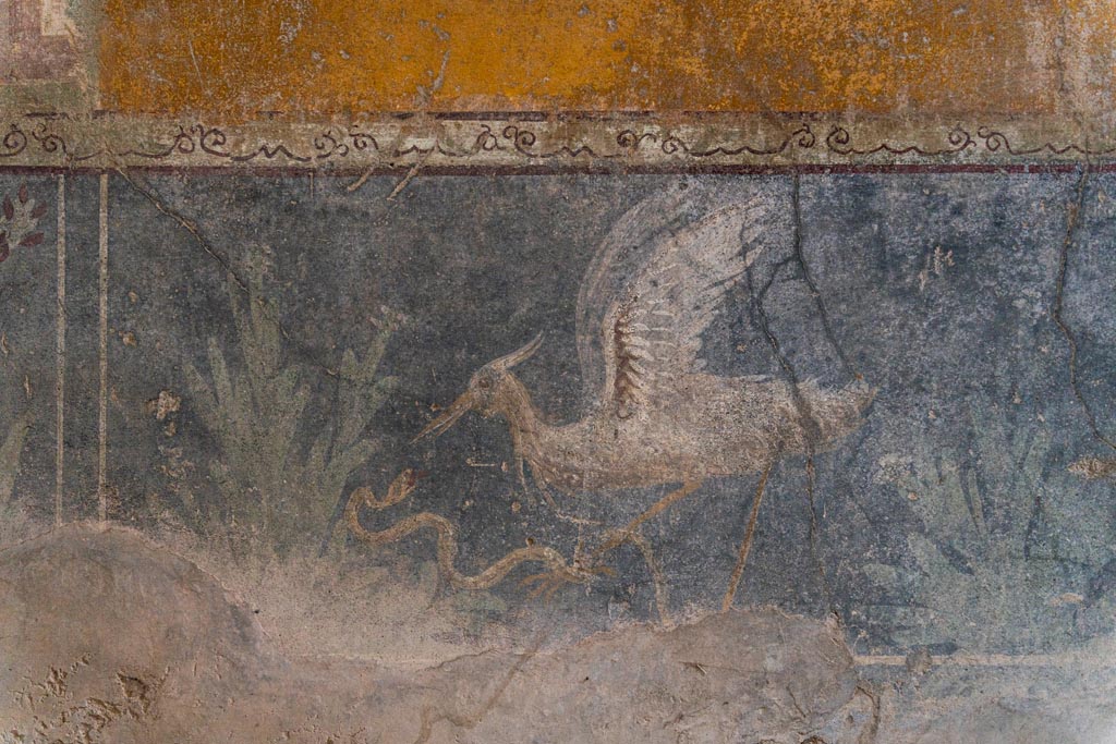 VI.16.15 Pompeii. January 2024. 
Room F, centre of zoccolo of lower west wall with painting of bird, serpent and plants. Photo courtesy of Johannes Eber.
