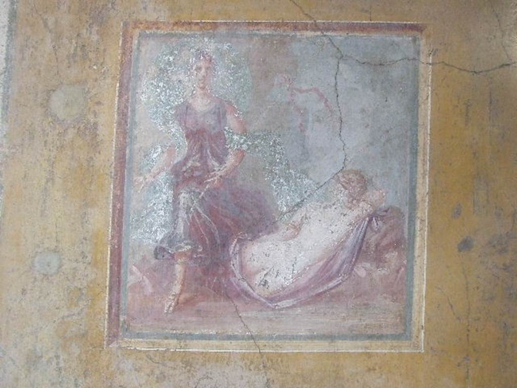VI.16.15 Pompeii. December 2006. Wall painting of The Sleeping Ariadne from the centre of the east wall of room F.  On the right Ariadne sleeps with her back to the spectators, near to her was a Bacchante. She was nude except for a peacock-blue mantle covering the lower part of her body. Around her arm was a large golden armband.  From the left arrived a Bacchante carrying a thyrsus in the left arm. See Notizie degli Scavi, 1908, (p.71-2)
