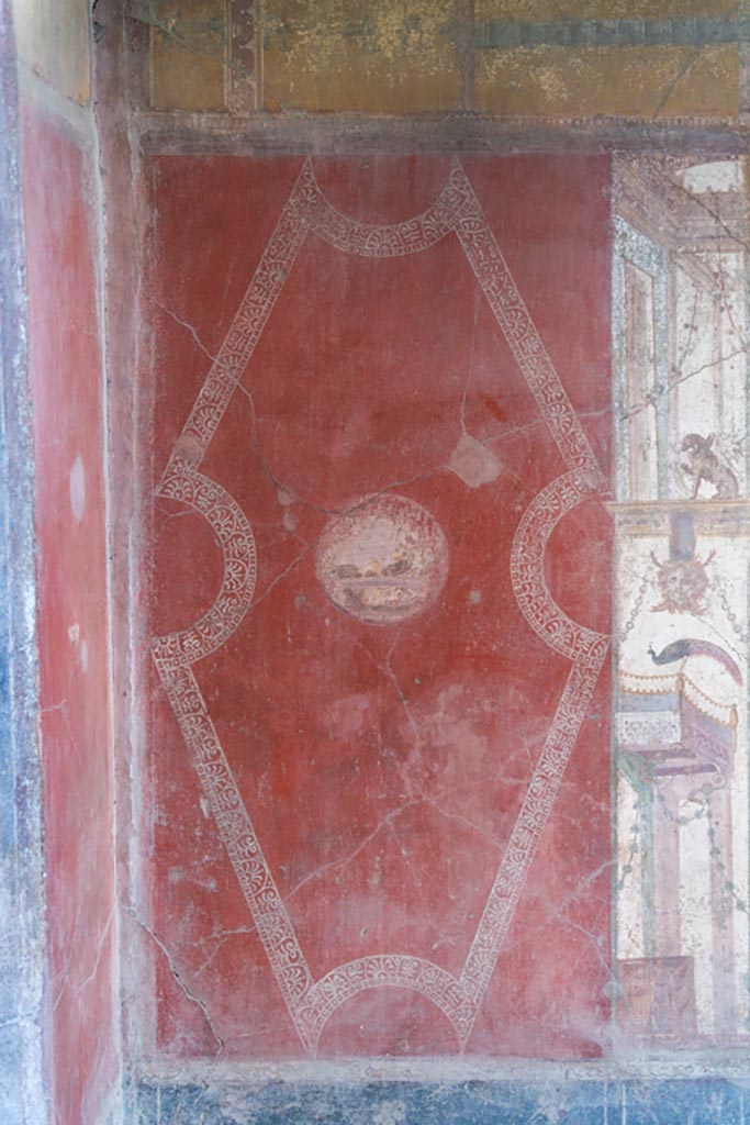 VI.16.15 Pompeii. January 2024. 
Room F, east wall at north end, painted red panel with medallion Photo courtesy of Johannes Eber.
