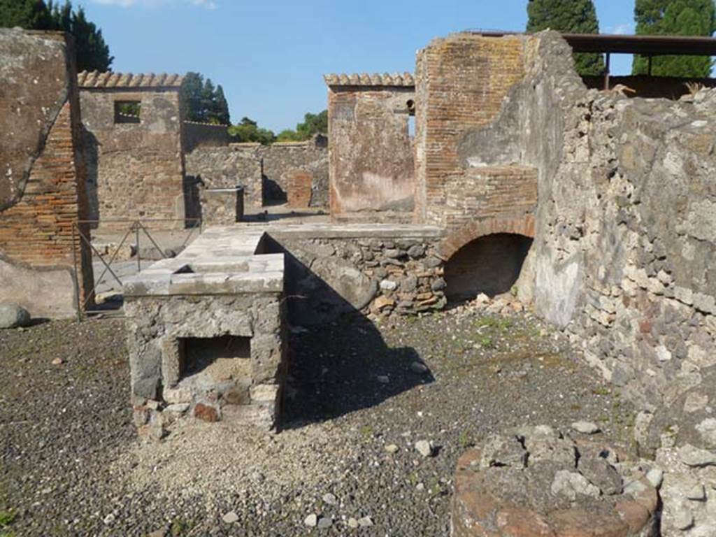 VI.17.4 Pompeii. May 2011. Looking east at rear of counter, looking towards Via Consolare.