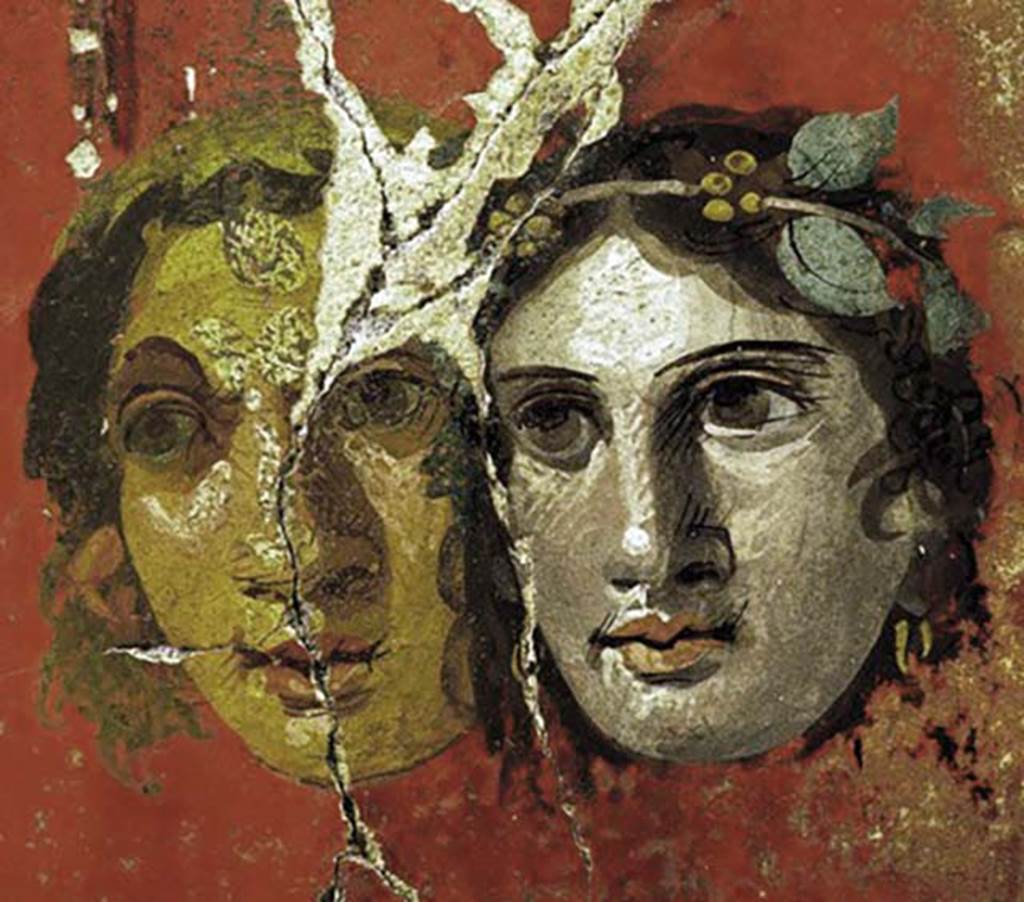 VI.17.42 Pompeii. Oecus 32. Detail of two faces from upper part of west wall. 
Inventory number 40693.
