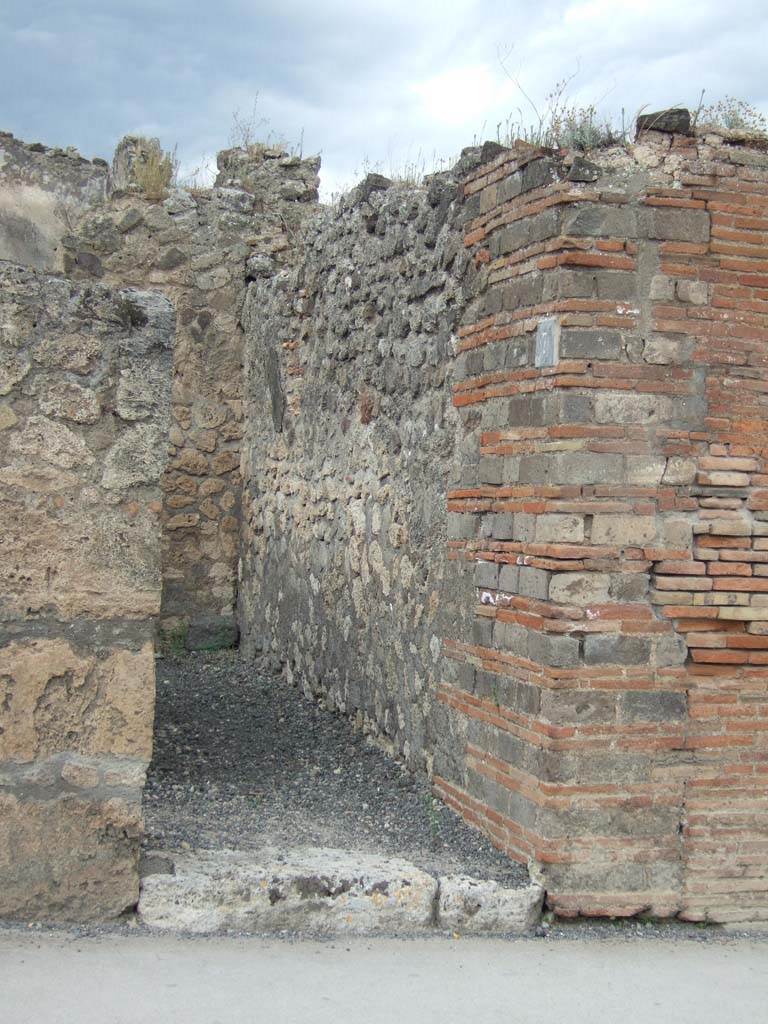 VII.14.7 Pompeii. May 2006. Looking north to site of stairs to upper floor, with latrine below, at rear.