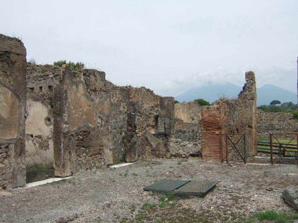 VIII.2.34 Pompeii. May 2006.  North-west corner of atrium c with doorway to small room L and doorway linking to room q, kitchen area and VIII.2.33.
