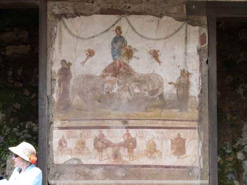 IX.7.6 Pompeii. May 2010. Fresco of Venus being pulled by elephants, outside House of Verecundus, between doorways IX.7.7 and IX.7.6. 
According to Della Corte, on the upper edge of the painting that presents the activity of the workshop, one reads the recommendation:   
Quactiliari (sic) rog(ant)  [CIL IV 7838] And beneath in very small black letters, the name:  Verecundus (7839). Near the lower edge of the painting, twice more - Verecundus (9084):  Verec(undus) (9085)
See Della Corte, M., 1965.  Case ed Abitanti di Pompei. Napoli: Fausto Fiorentino. (p.279)
According to Epigraphik-Datenbank Clauss/Slaby (See www.manfredclauss.de), CIL IV 7838 reads as 
Vettium Firmum aed(ilem) <co=QV>actiliari(i) rog(ant)


