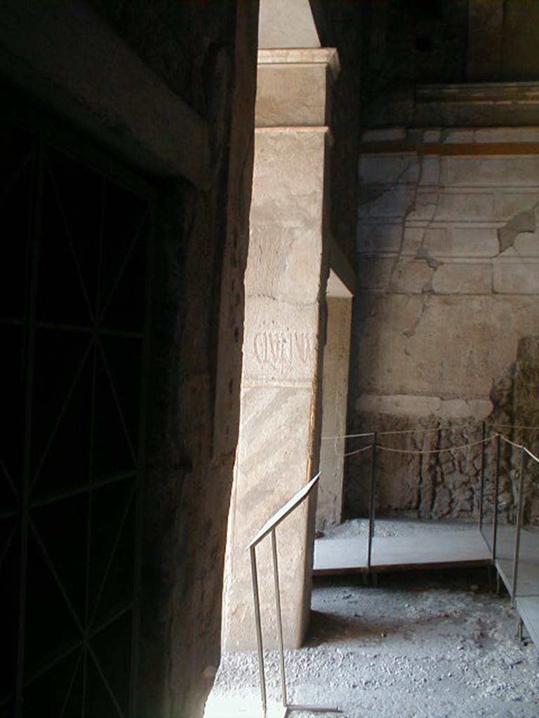 IX.13.1-3 Pompeii. September 2004. Room 1. Looking west towards entrances IX.13.3 (with graffito) and IX.13.2 (entrance).


