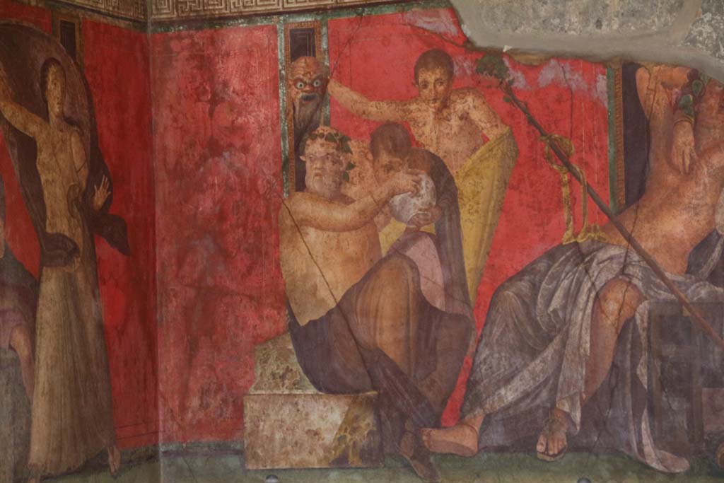 Villa of Mysteries, Pompeii. April 2014. 
Room 5, a Silenus and satyrs, theatrical mask in hand, consume wine, detail from east wall of painting of Dionysian mystery, in north-east corner. 
Photo courtesy of Klaus Heese.

