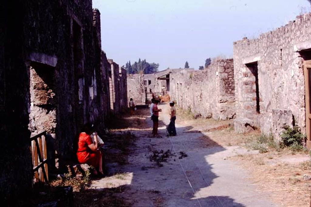 Via di Castricio, Pompeii. 1974. Looking west from near I.15.2/3 ,on left, and I.12.11/10, on right.  Photo by Stanley A. Jashemski.   
Source: The Wilhelmina and Stanley A. Jashemski archive in the University of Maryland Library, Special Collections (See collection page) and made available under the Creative Commons Attribution-Non Commercial License v.4. See Licence and use details. J74f0492
