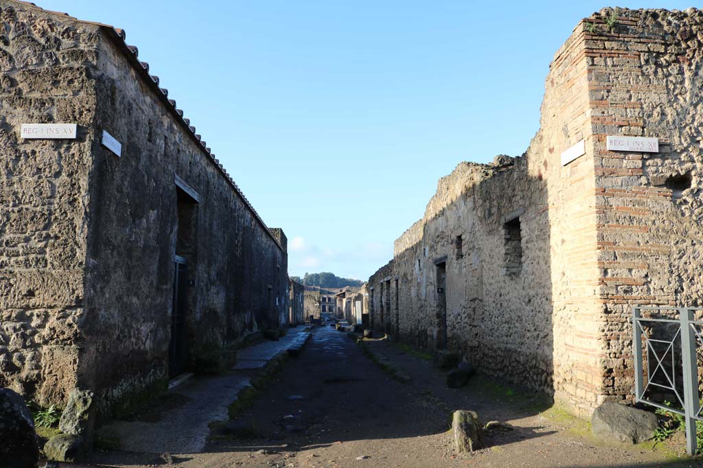 Via Castricio,Pompeii. December 2018. 
Looking west between I.15 and 1.12, from the junction with Vicolo dei Fuggiaschi. Photo courtesy of Aude Durand.
