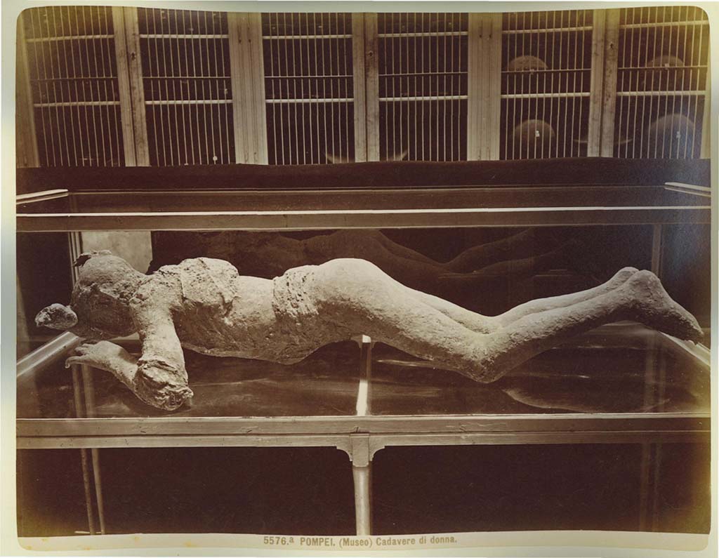 Victim number 10, the young girl from Strada Stabiana. Photo: Edizioni Brogi (no.5576a, side view). Photo courtesy of Eugene Dwyer.
In his description of this plaster-cast in his Guida di Pompei, 1877, Fiorelli described –
“Young woman [no.10], face down, with her head resting on her arm. She is denuded in part of her clothing, save for some traces on her shoulders, and her tresses are still visible, with hair knotted behind her head. (Reg. VI. Ins XIV, cardo).”
See Fiorelli, Guida di Pompei, [Rome, 1877,] p.88-89. 
See Dwyer, E., 2010. Pompeii’s Living Statues. Ann Arbor: Univ of Michigan Press, (p.93).
