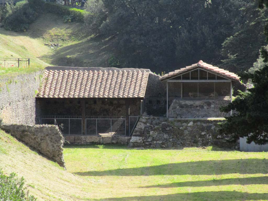 North-west side of Via delle Tombe. April 2019. 
Looking east towards display area showing the plaster-casts of some fleeing fugitives. 
Four victims were found between September 1956 and March 1957. Plaster casts were made. Photo courtesy of Rick Bauer.

