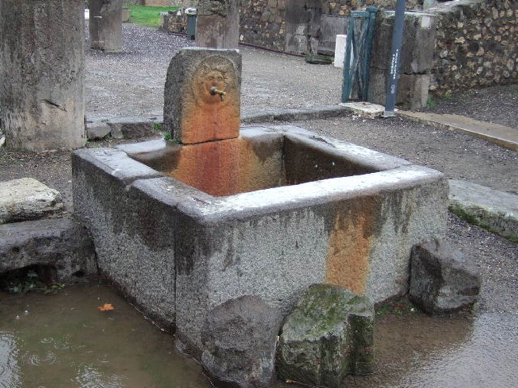 Outside VIII.2.11, Pompeii. December 2005. Looking north-east at fountain on Via delle Scuole.