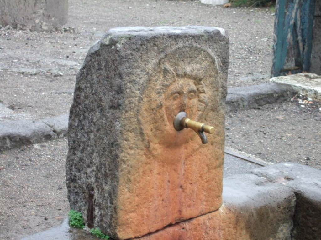 Outside VIII.2.11, Pompeii. December 2005. Fountain pilaster with relief of head of gorgon.