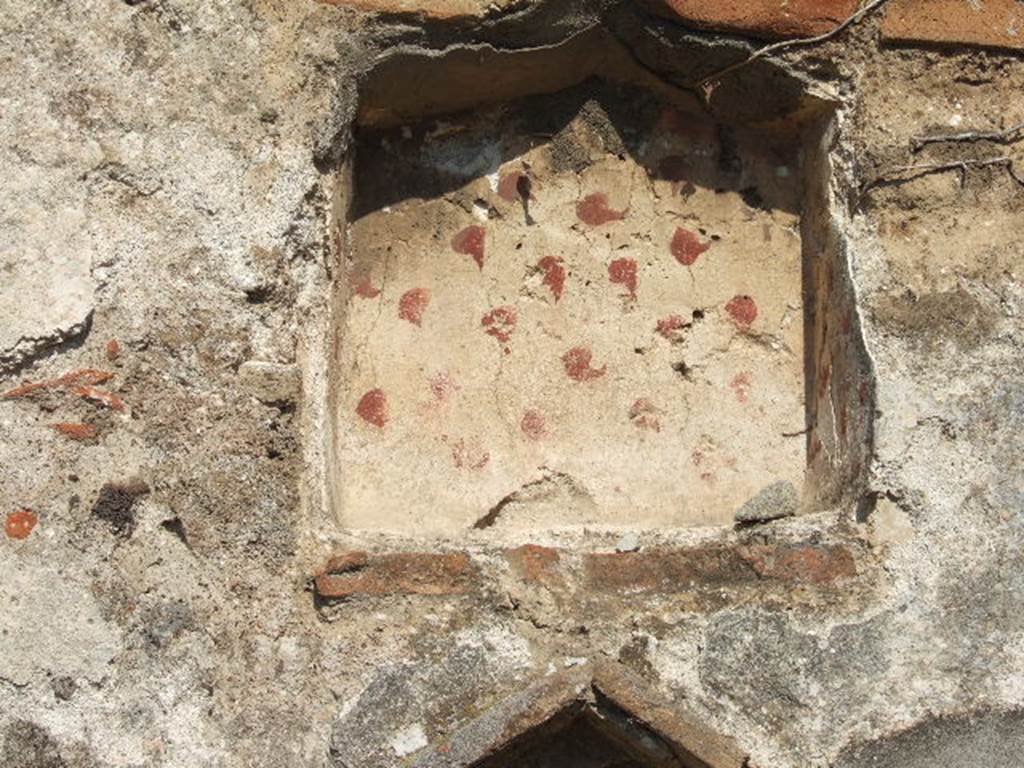 VII.12.13 Pompeii. September 2005. Detail of lararium niche on east wall near oven.
According to BdI, a lararium painting was discovered in this bakery during the last year.
The picture was described by Sig. Reifferscheid in AdI 1863, p.126, item delta.
See BdI, 1864, p.116 (described as Casa V)..
According to Fiorelli, at the rear of the corridor was an area discovered with oven and hearth, where besides the altar and serpents (of the lararium painting), a few traces remained of the Lares to the sides of a niche.
See Pappalardo, U., 2001. La Descrizione di Pompei per Giuseppe Fiorelli (1875). Napoli: Massa Editore. (p.111)
