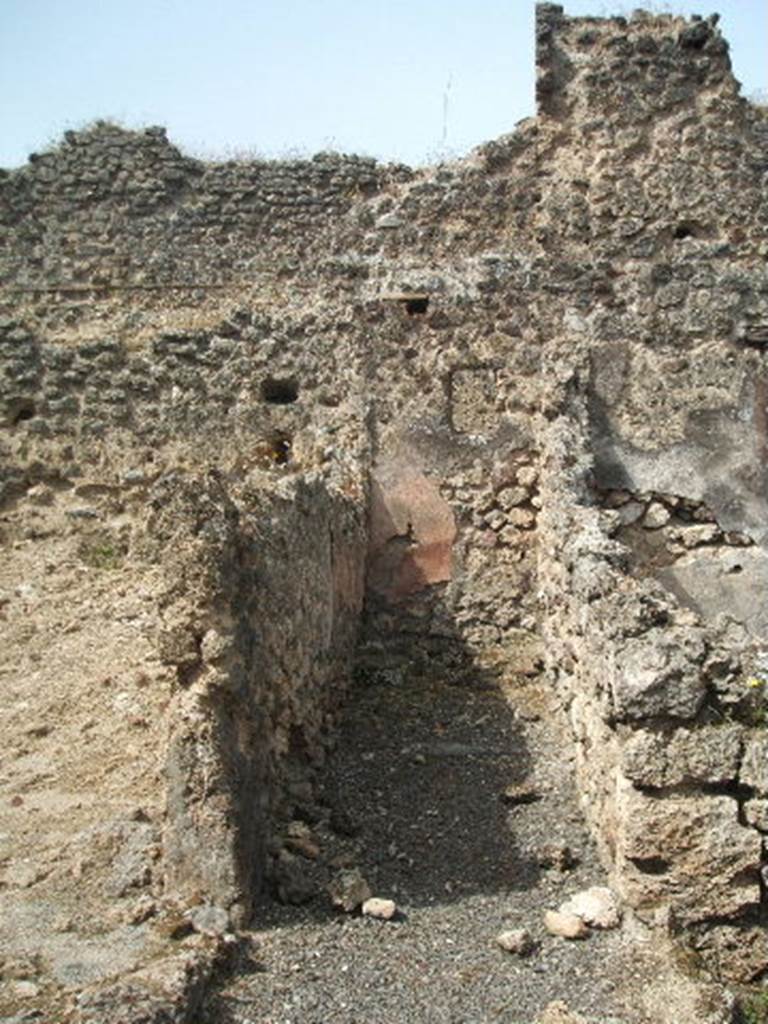 Pompeii. May 2005. Corridor leading to latrine. Looking west. According to Boyce, on the south wall of the passage leading to the latrine was painted the figure of Fortuna. See Boyce G. K., 1937. Corpus of the Lararia of Pompeii. Rome: MAAR 14. (p.88, no.442 and Pl. 26,2) 
