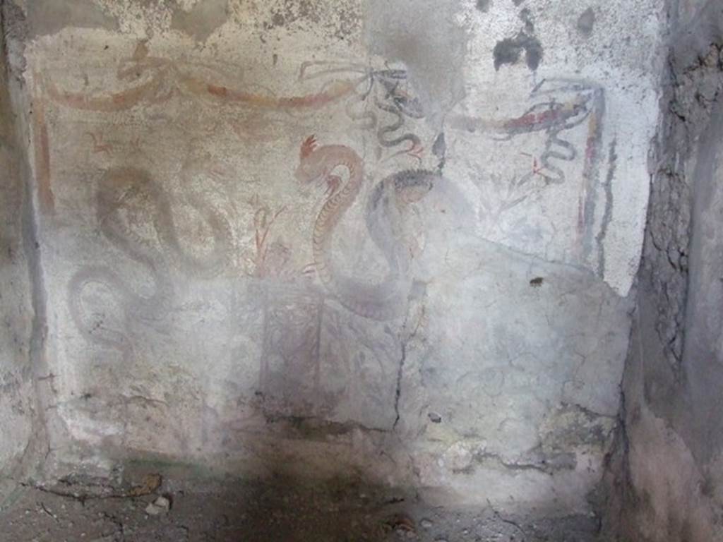 V.2.i Pompeii. March 2009. Room 26, lararium painting on west wall.  Two serpents approaching a round altar painted in a marble pattern, with a fire and a pine cone on the top. Above is a triple garland below which is a single bird in flight. See Boyce G. K., 1937. Corpus of the Lararia of Pompeii. Rome: MAAR 14.  (p.38, no.110 and Pl. 28,2)
See Fröhlich, T., 1991. Lararien und Fassadenbilder in den Vesuvstädten. Mainz: von Zabern. (L49).
