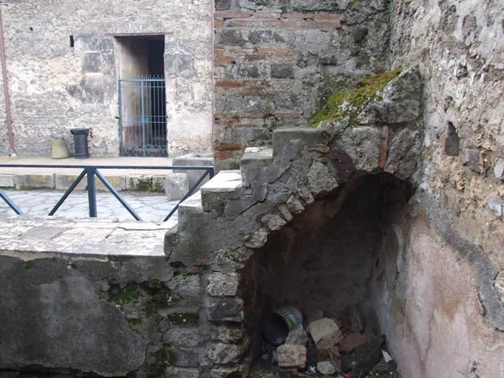 VI.10.1 Pompeii. March 2009. Looking west towards marble display shelving at end of counter, with recess below.