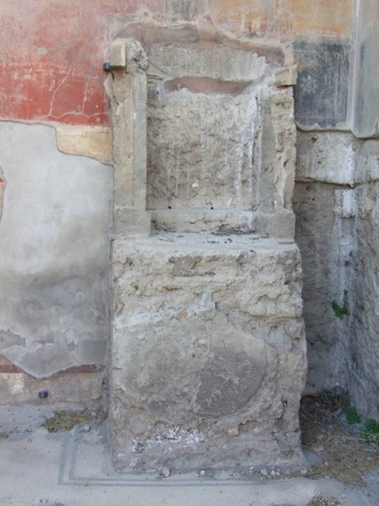 VII.4.31/51 Pompeii. March 2009. Room 6, lararium against west wall. 
On the front of the base there is an impression of a round plaque in the plaster.  
This must have once decorated it.
According to Boyce – in the left ala of the atrium stands an aedicula lararium.
Above a high podium (1.10 by 0.93, h.1.22), walls enclose a rectangular niche (h.0.96, w.0.80, d.0.50), the sides of which are reported to have been originally covered with marble.
See Boyce G. K., 1937. Corpus of the Lararia of Pompeii. Rome: MAAR 14. (p.66, no. 277)
See Giacobello, F., 2008. Larari Pompeiani: Iconografia e culto dei Lari in ambito domestico. Milano: LED Edizioni, (p.244, no.A26)


