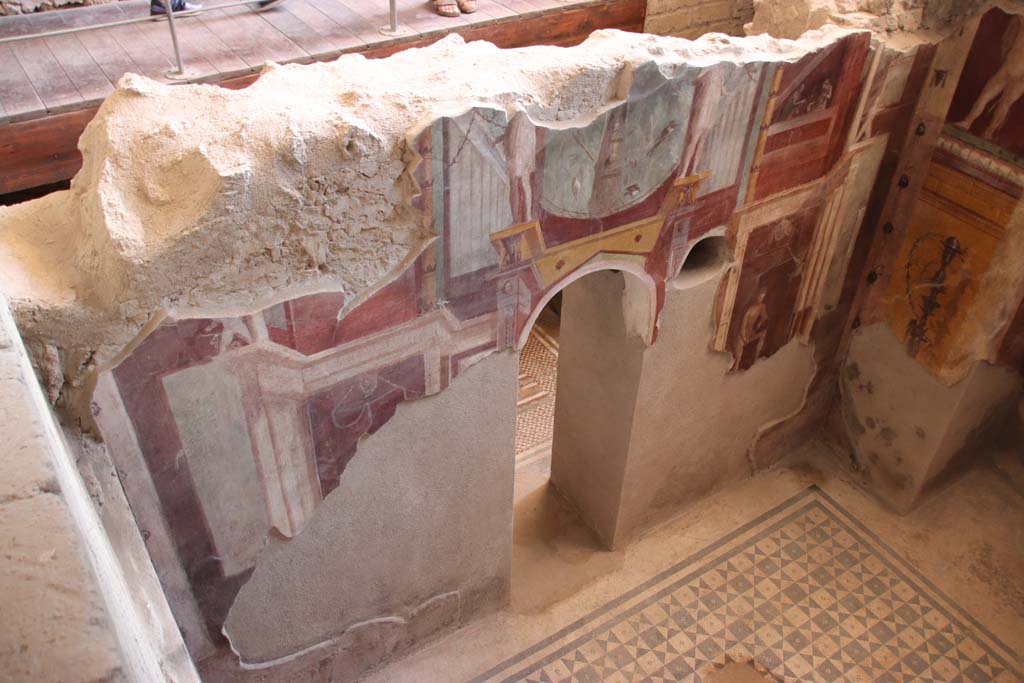 I.6.2 Pompeii. September 2019. Looking down on south wall of frigidarium, with arched doorway to anteroom or changing room. 
Photo courtesy of Klaus Heese. 
