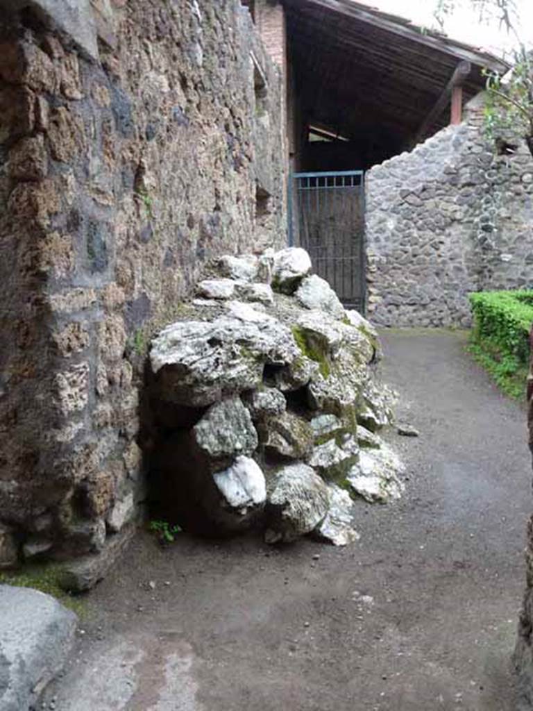 I.6.4 Pompeii. May 2010. Room 9, east side of small garden area with remains of ancient building material.