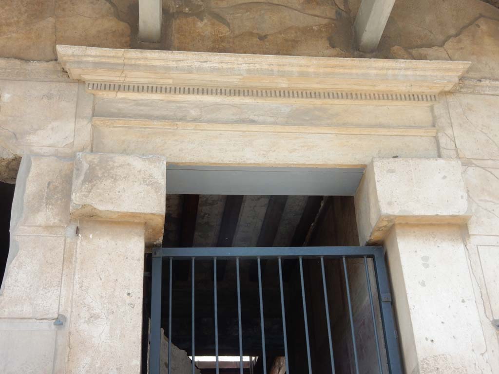 I.6.15 Pompeii. June 2019. Detail above entrance doorway. Photo courtesy of Buzz Ferebee.