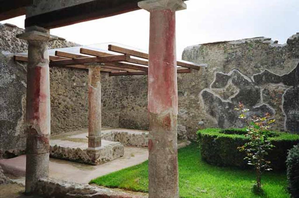 I.8.9 Pompeii. March 2010. Room 9 and garden area with restored triclinium.  
Photo courtesy of Rick Bauer.
