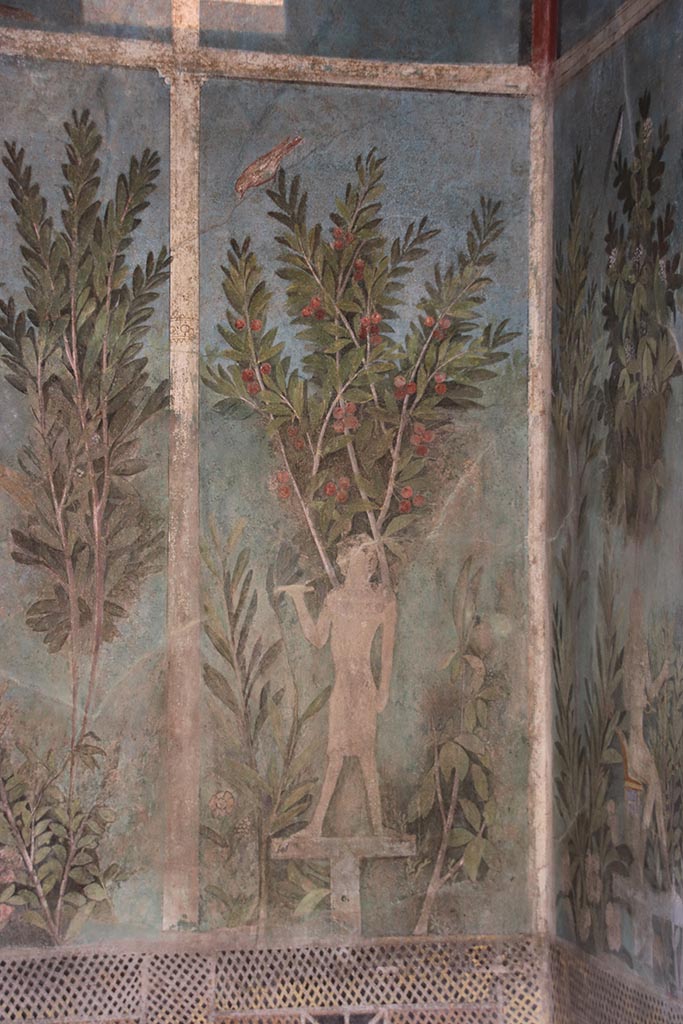 I.9.5 Pompeii. October 2024. 
Room 5, detail of painting of Egyptian pharaonic statue and cherry tree from south end of east wall of cubiculum.
Photo courtesy of Klaus Heese.
