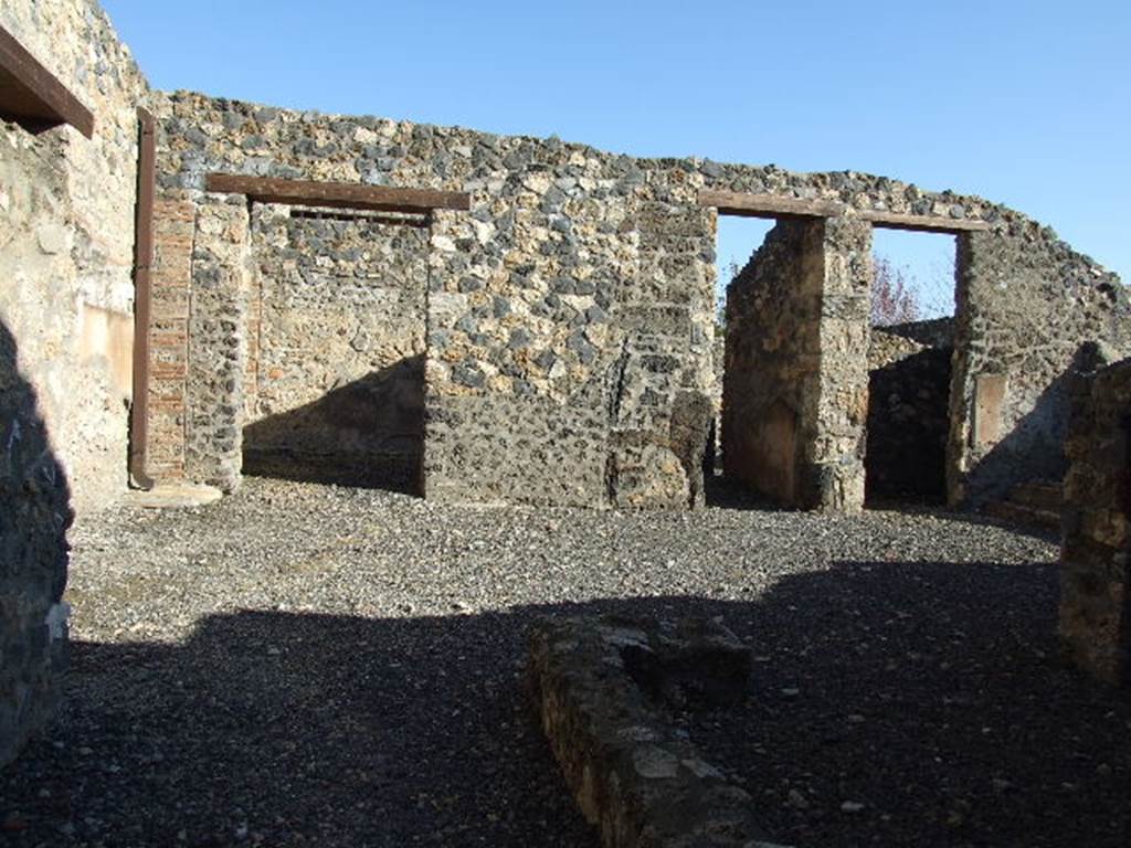 I.11.15 Pompeii. December 2006. Atrium, looking east to room 5, corridor room 6 and room 7.  Doorway to room 8 is just visible on left behind end of entrance corridor wall.

