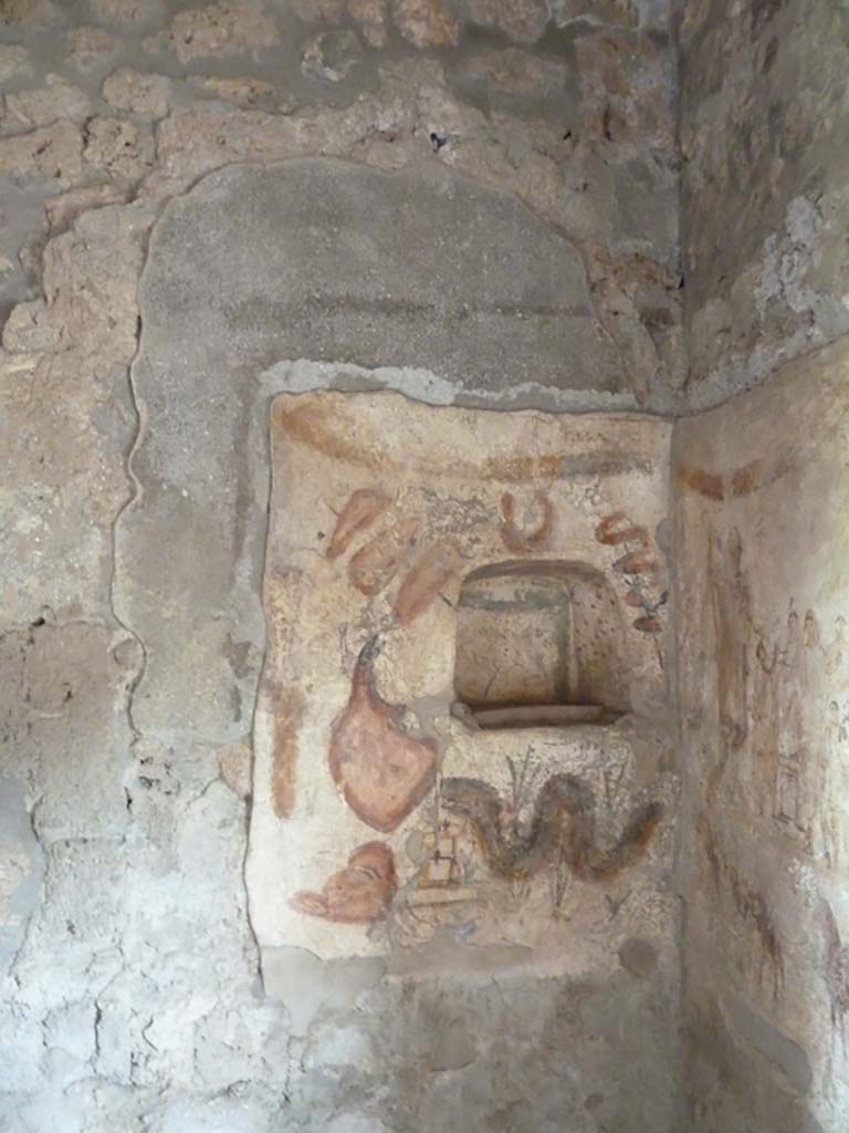 I.13.2 Pompeii. May 2010. Kitchen, north wall. Painted lararium with niche, and serpent below.