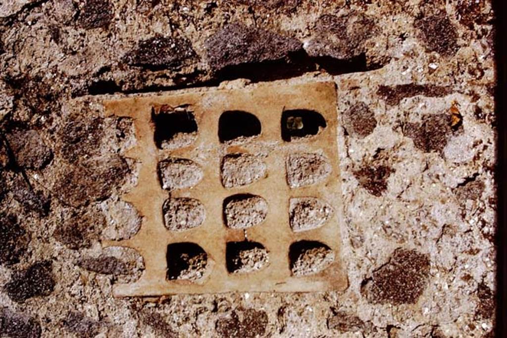 I.15.3 and I.15.5/6 Pompeii. 1972. Terracotta window from south end of rear wall of I.15.5/6. Photo by Stanley A. Jashemski. 
(Note: On first view we thought this photo was sideways on, but looking at the photo two above of the wall, this is the way it is in the wall.)
Source: The Wilhelmina and Stanley A. Jashemski archive in the University of Maryland Library, Special Collections (See collection page) and made available under the Creative Commons Attribution-Non Commercial License v.4. See Licence and use details.
J72f0612 
