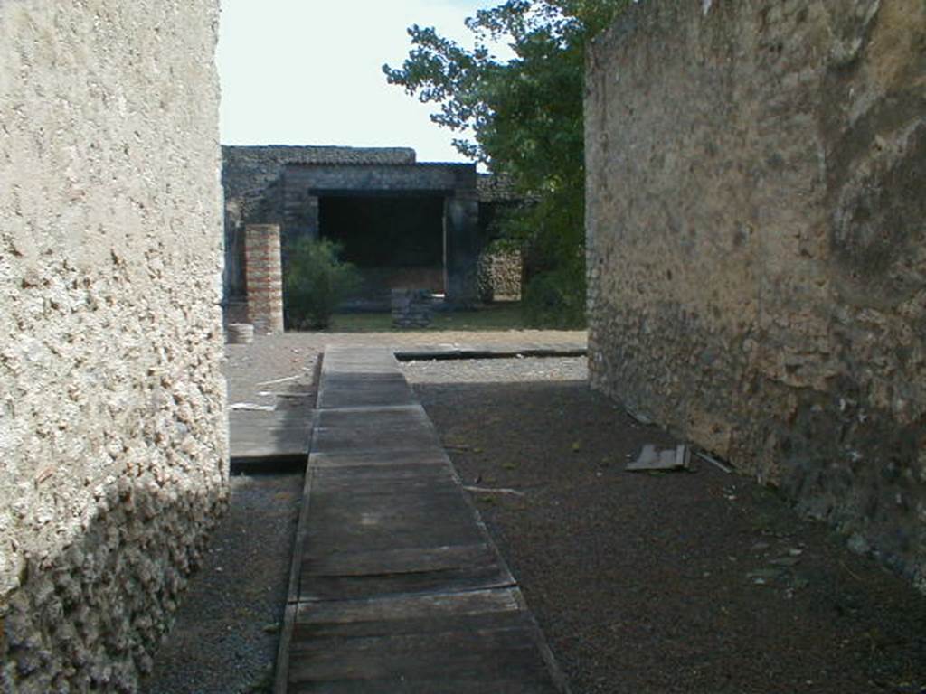 II.1.12 Pompeii. September 2004. Looking east along fauces to an area, originally the atrium that had lost its function. This area would then have led into the peristyle area, with altar and sacellum, at the rear. See, Pace, R: (1997). Il Complesso dei Riti Magici a Pompei II.1,11-12.  In Rivista di Studi Pompeiani, VIII, 1997, Rome, LErma di Bretschneider, (p.73-97)
