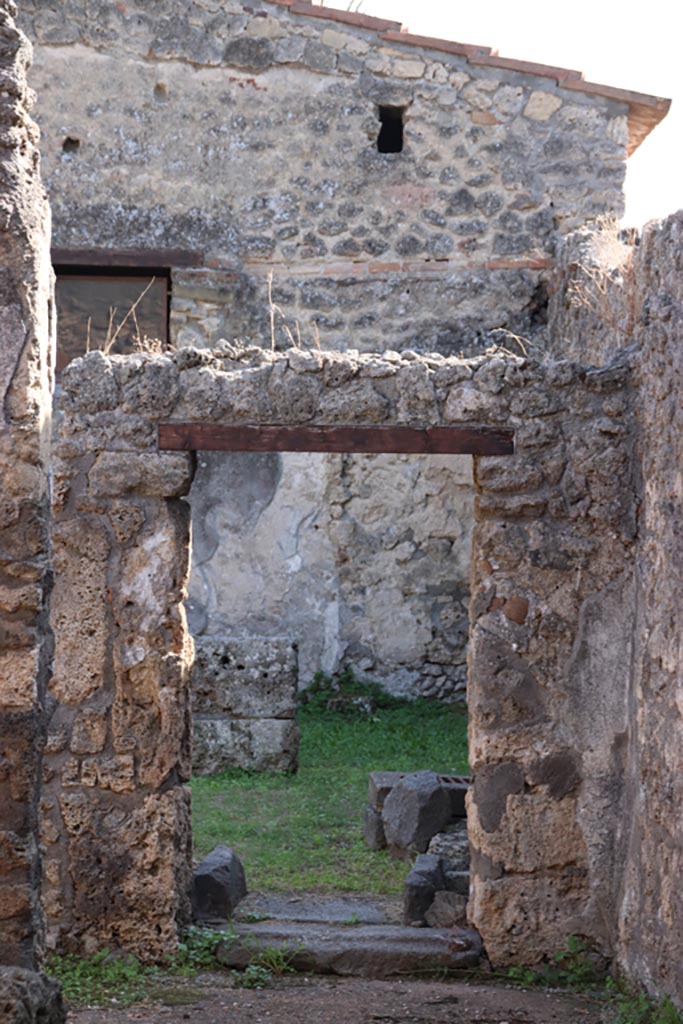 II.1.13 Pompeii. October 2023. 
Looking south through doorway of dining room, photo taken from II.1.1. Photo courtesy of Klaus Heese.
