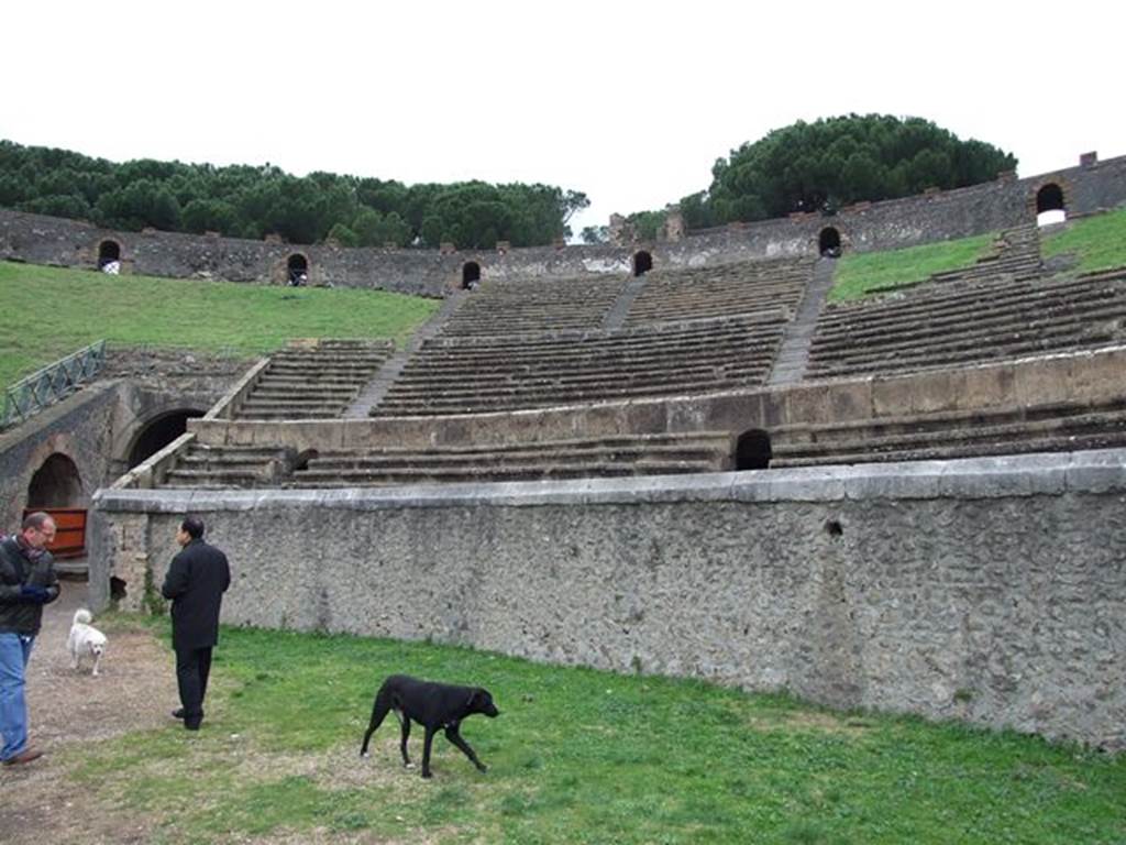 II.6 Pompeii. December 2006. Arena and seating of Amphitheatre, north-east corner. 
Incised in the capping stone on the rim of the arena wall is an inscription.
T. ATVLLIVS C. F. CELER IIV PRO. LVD. LV. CVN. F. C. EX. D. D.

According to Epigraphik-Datenbank Clauss/Slaby (See www.manfredclauss.de) this expands to

T(itus) Atullius C(ai) f(ilius) Celer IIv(ir) pro lud(is) lu(minibus) cun(eum) f(aciendum) c(uravit) ex d(ecreto) d(ecurionum)      [CIL X 854]

According to Cooley, this translates to 
Titus Atullius Celer, son of Gaius, duumvir, instead of games and lights, saw to the construction of a seating sector, by decree of the town councillors.
See Cooley, A. and M.G.L., 2004. Pompeii: A Sourcebook. London: Routledge, D2, p. 47.

