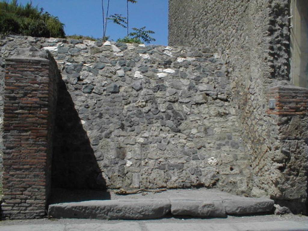 III.3.5 Pompeii. May 2005. Blocked entrance doorway, partly excavated.

According to Garcia y Garcia, a bomb dropped during the bombardment of 19th September 1943 destroyed the faade of this shop.
This led to the disintegration of the pilasters and doorposts of three entrances, (III.3.3, 4 and 5).
Also ruined were the dividing walls and the perimeter wall onto Via dellAbbondanza for 26 x 5 metres.
In III.3.5 the internal walls were also destroyed.
See Garcia y Garcia, L., 2006. Danni di guerra a Pompei. Rome: LErma di Bretschneider. (p.53)
